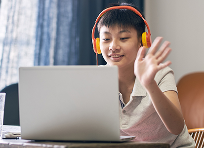 teen student with laptop and headphones