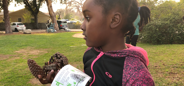 a kid participating in a biometry class outside the library