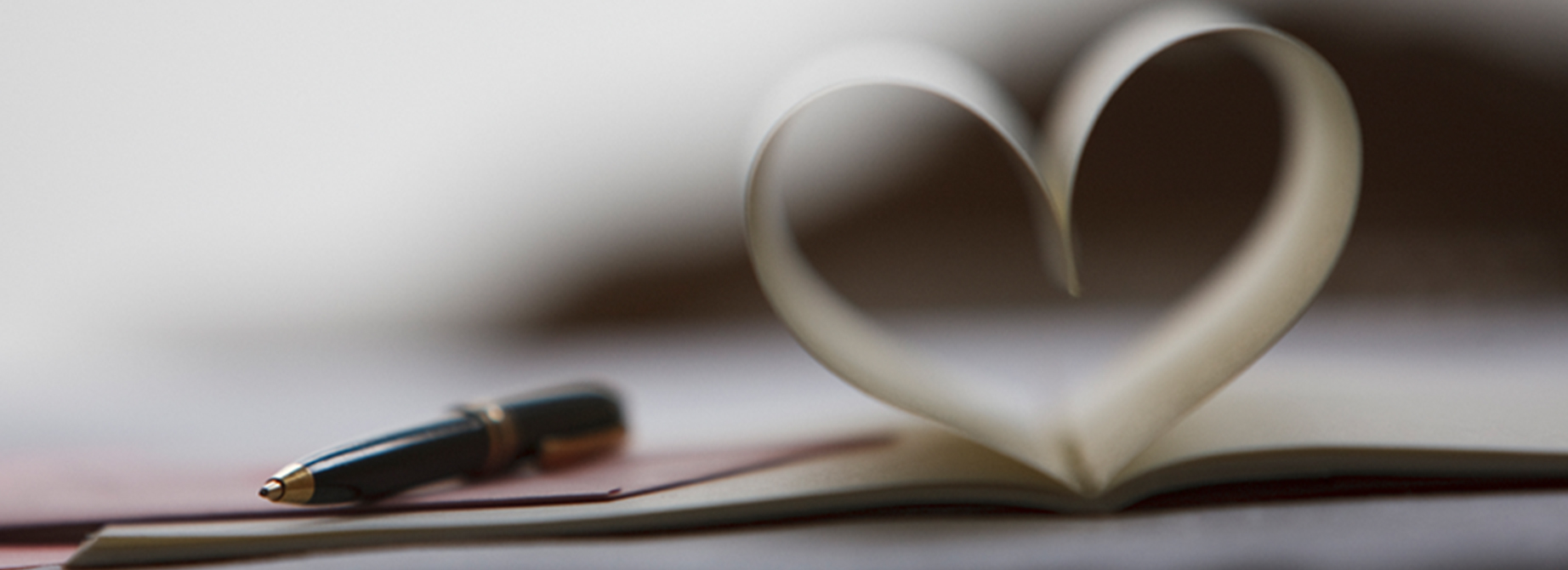 open book with pages shaped into a heart