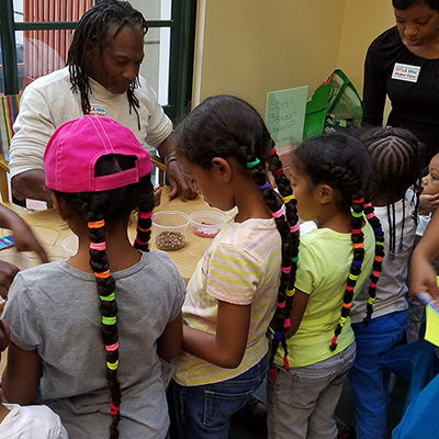 four girls looking at beads