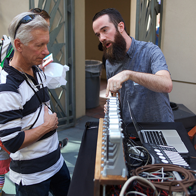 Two men looking at a fork organ