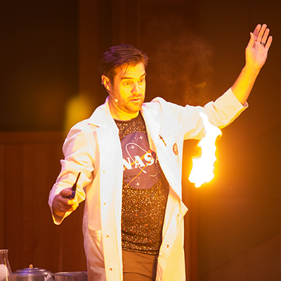 man in lab coat with fire magic