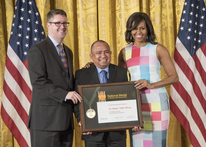 City Librarian John F. Szabo, Los Angeles community member Sergio Sanchez and First Lady Michelle Obama