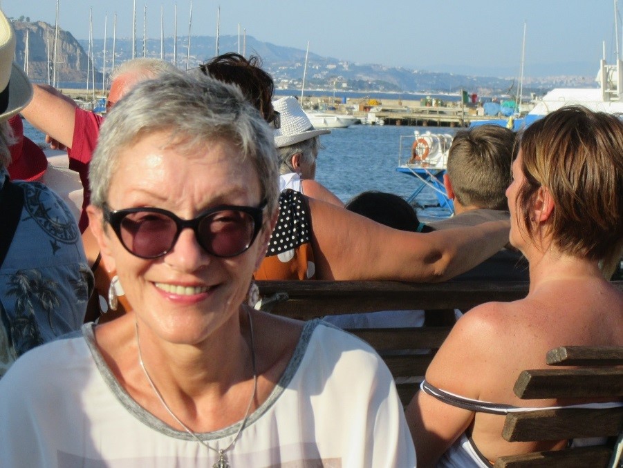 the author smiling while sitting as a passenger on a ferry