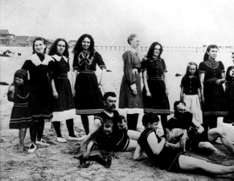 A group of bathers - men, women and children - pose at the water's edge in Newport Beach