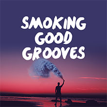 a man standing against a purple sunset outside, holding a huge smoke signal flame