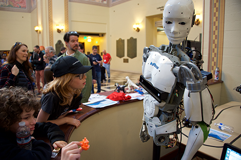 Kids and adults admiring robot