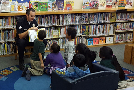 Officer Joe reading to children in the library