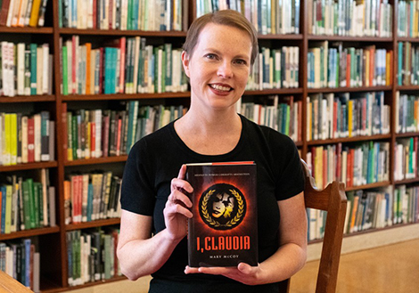 Author Mary McCoy holding her book I Claudia