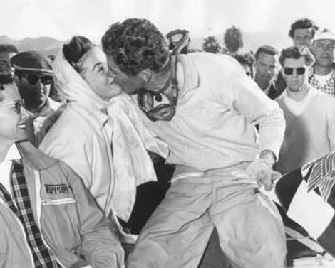 Race car driver Carroll Shelby gets a kiss from his wife