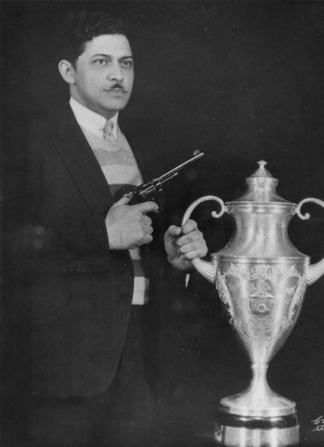 Dr. Eugene poses with his trophy and his weapon in 1935