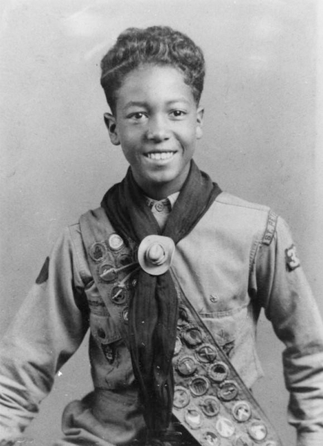 Boy Scout William Legget poses with his merit badges in 1936