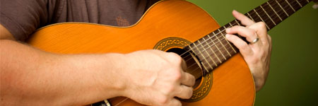 arm strumming a guitar