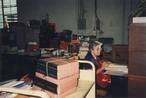 Librarian repairing books
