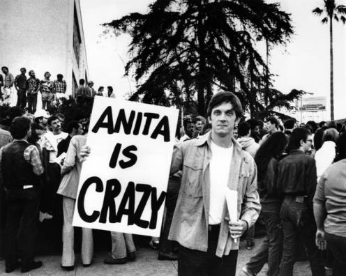 man hold Anita is Crazy sign