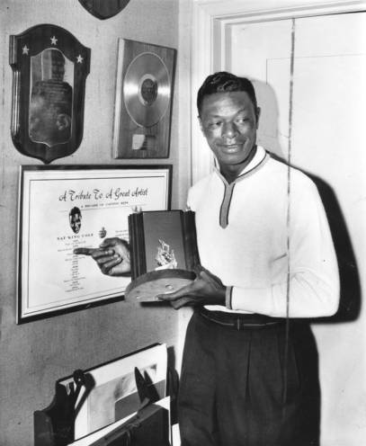 Photo of Nat 'King' Cole with some of his awards.