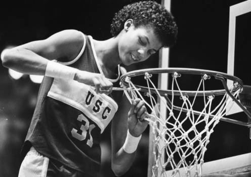 USC's Cheryl Miller cuts down a basketball net during Trojan's post-game celebration.