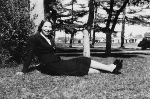 Miriam Matthews sitting on lawn of Watts Library