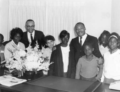 Reverend Thomas Kilgore pictured with Reverend Martin Luther King Jr. with a group of youth.