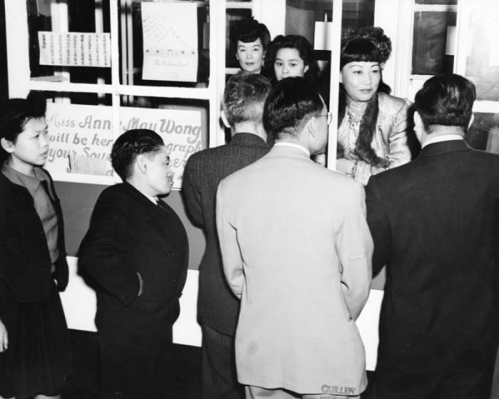 Anna May Wong signs autographs