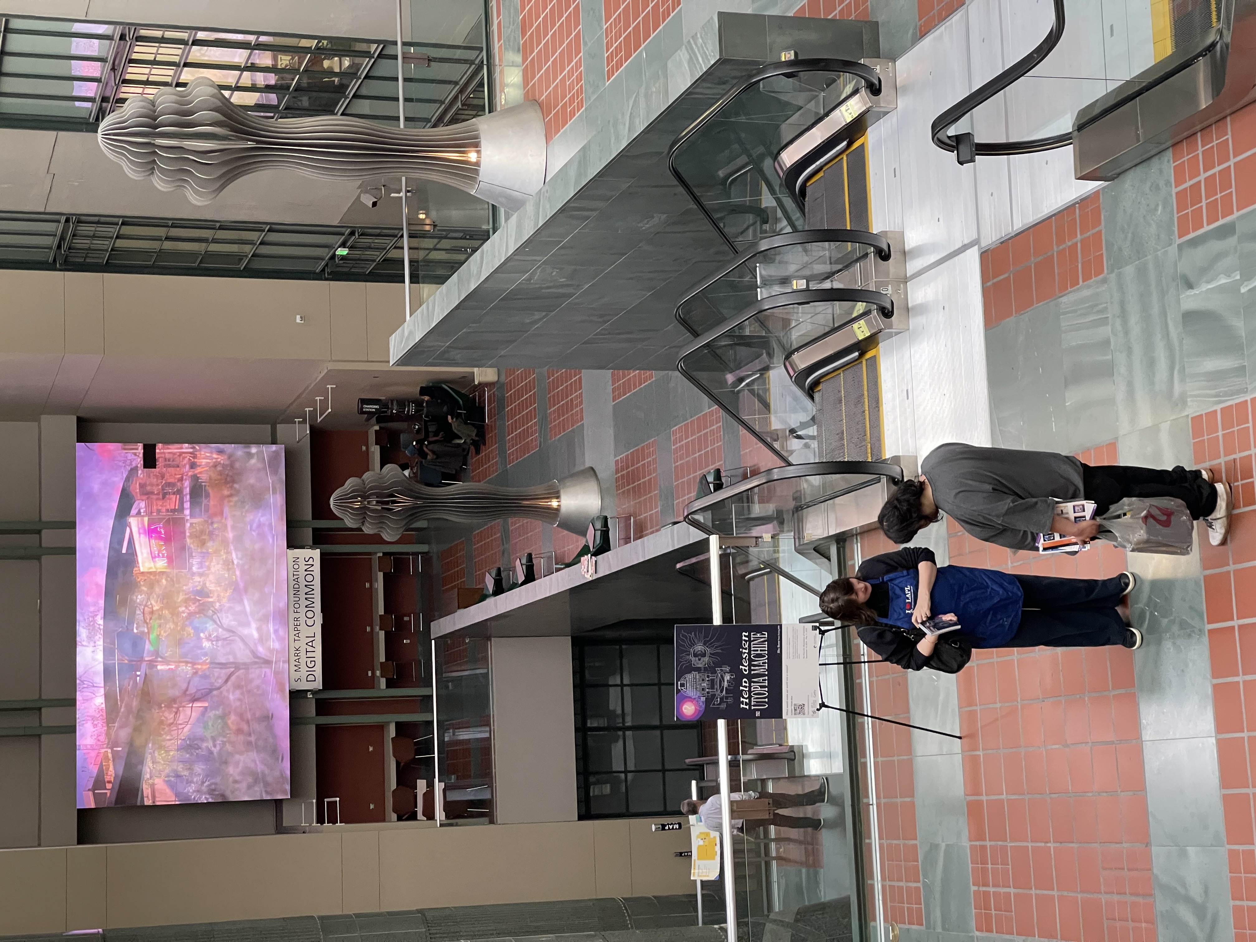 Ellen Harvey in the L.A. Central Library talking with Library patron