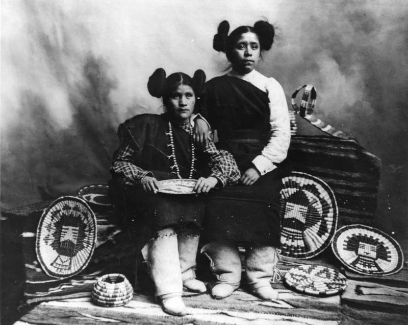 Hopi Indian girls in traditional dress and basketry