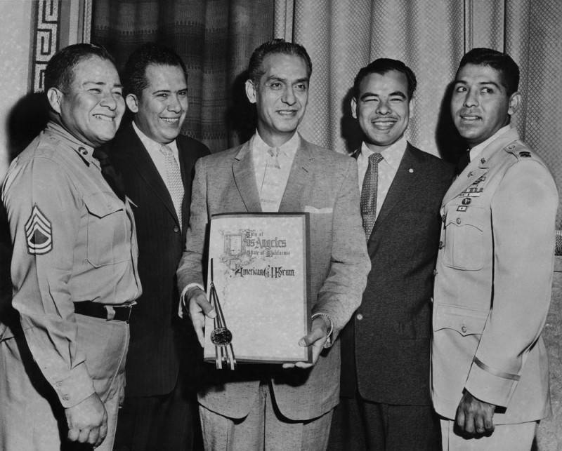  Edward Roybal is shown holding a certificate of merit given by the City of Los Angeles