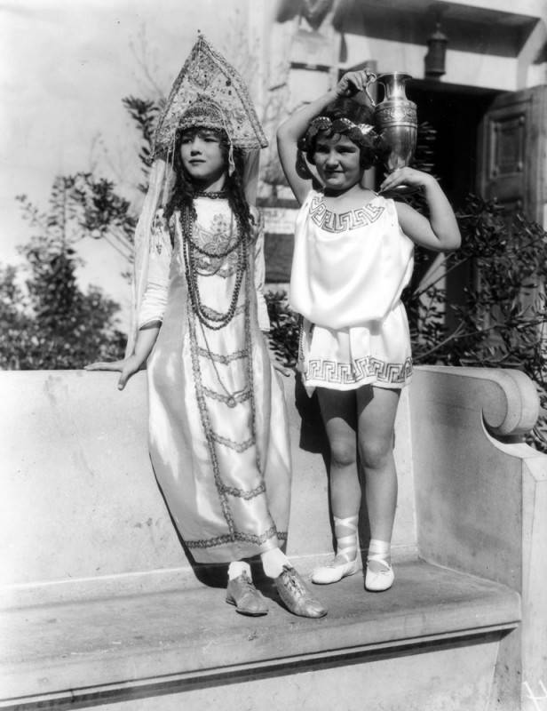 Two young girls dressed in outfits that represent the Russian and Greek languages 1928