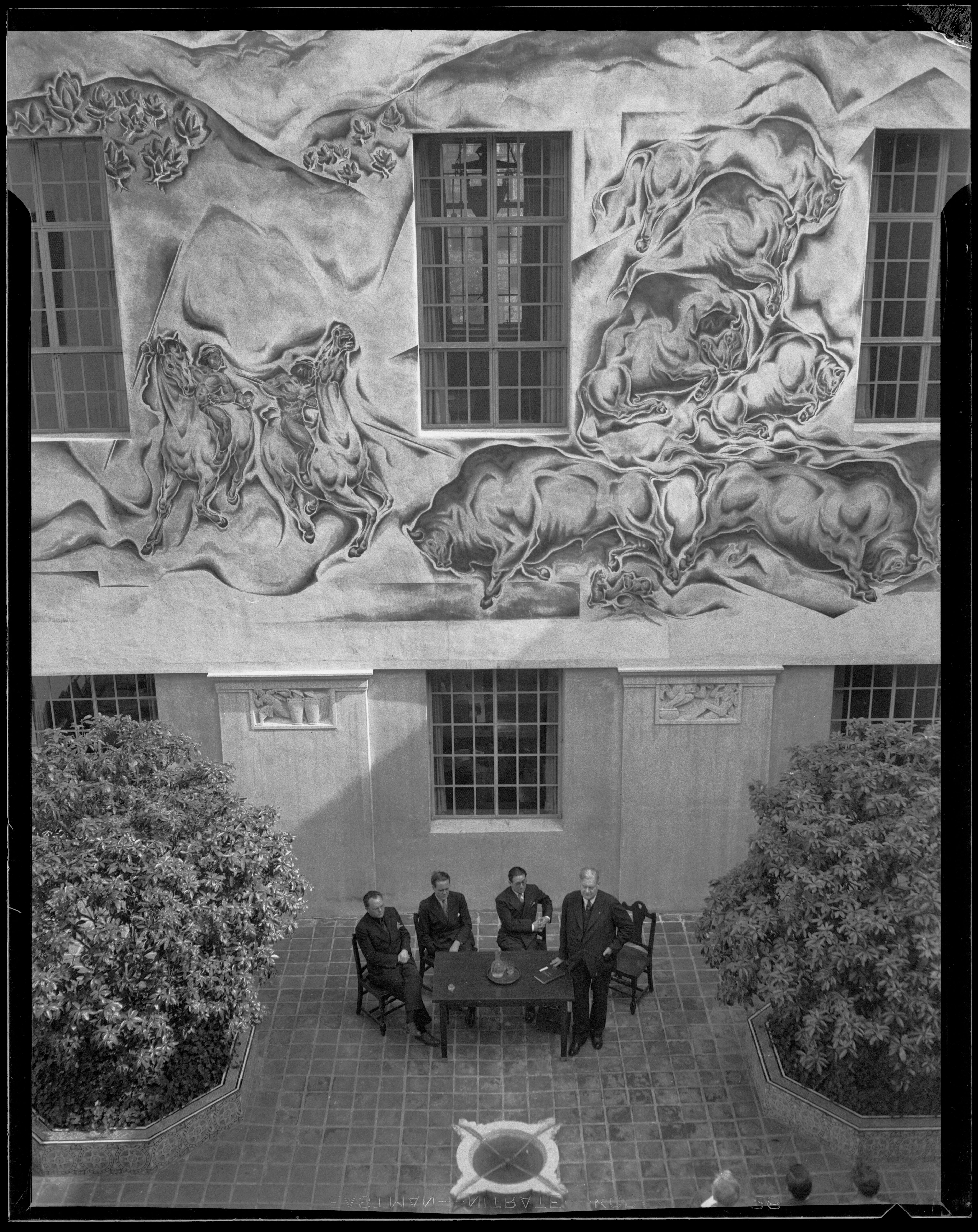 Merle Armitage, Charles Kassler Jr., Alfred A. Cohn and Orra E. Monnette in the library courtyard 1934