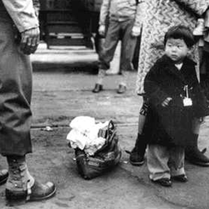 Japanese-American Child Being Evacuated with His Parents