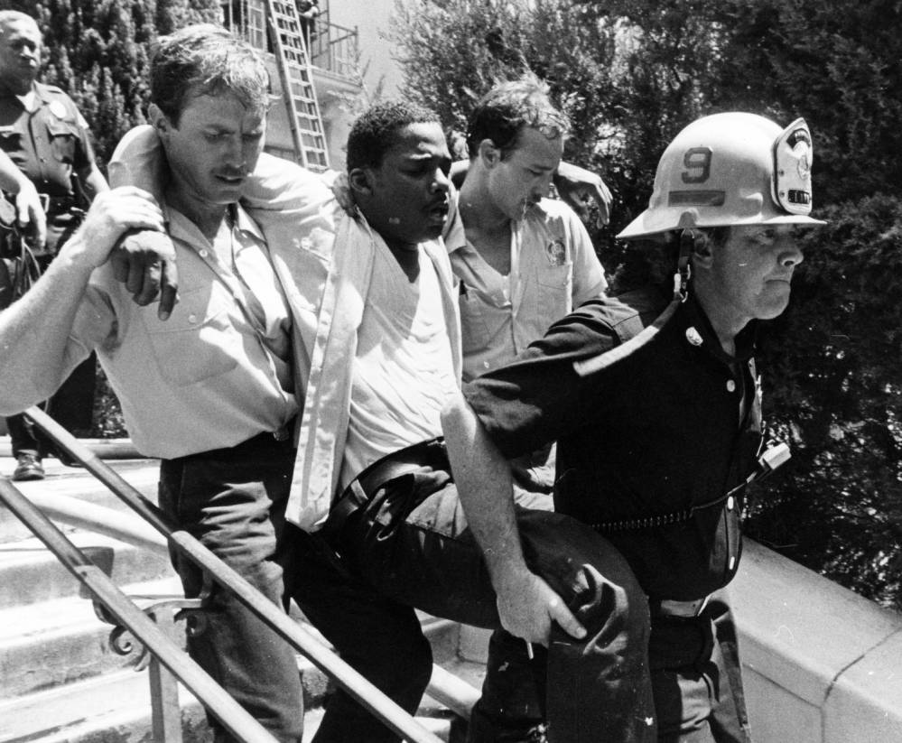 Injured firefighter is carried out of Central Library 