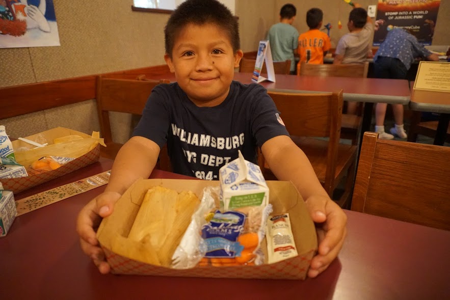 smiling little boy at summer lunch kickoff