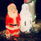 A santa and a ghost decoration on a porch