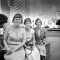 Three librarians are pictured in front of the burning Central Library 