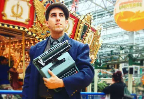  Brian Sonia-Wallace holding a typewriter