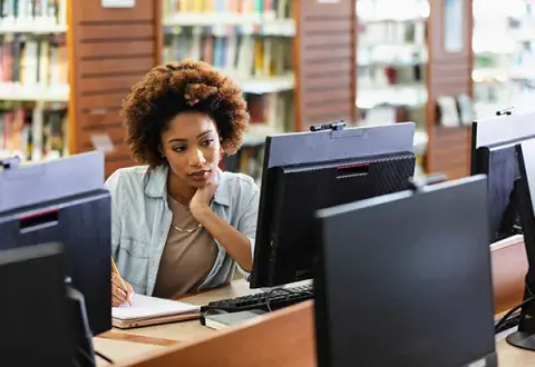 woman using library desktop computer