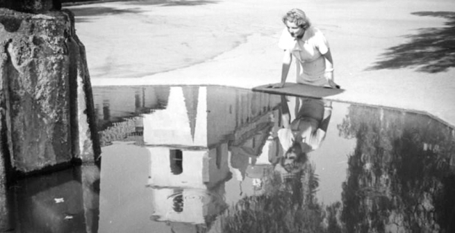 Ethel Schultheis looks into a large fountain