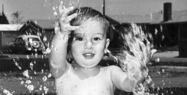 Baby splashing in a pool