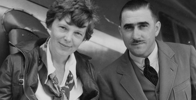 Amelia Earhart and technical expert Paul Mantz study the route Earhart undertook in a flight from the Hawaiian Islands to California, the longest over-water flight ever undertaken at that time.