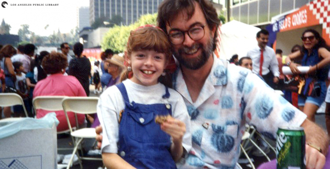 Glen Creason and his daughter Katya celebrate the re-opening of Central Library on a closed-off 5th Street