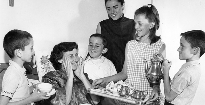 Mrs. Elwood Berney lying in bed with her children