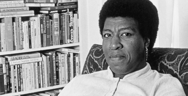 Octavia E. Butler seated by her bookcase, 1986