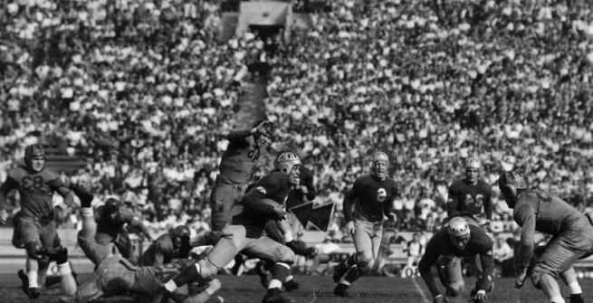 The University of California at Los Angeles after trailing California at Berkeley through the first quarter, finally came into its own at the Memorial Coliseum. In this photo, Kenny Washington, brilliant Bruin halfback, is away to a smashing gain as his teammate, Woody Strode, effectively blocks out the California secondary defense. Dated November 4, 1939
