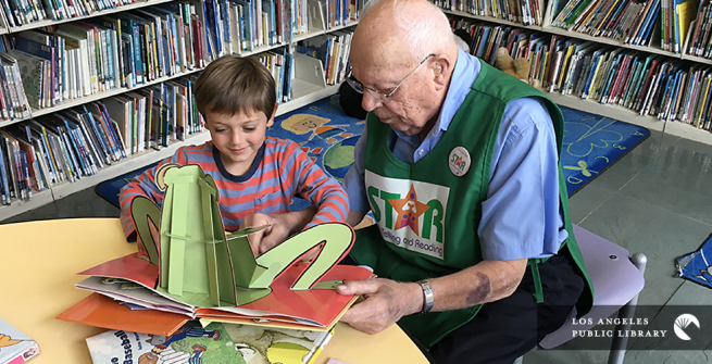 Senior reading to a child at the library
