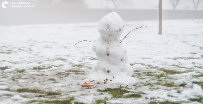 melting snowman in a field