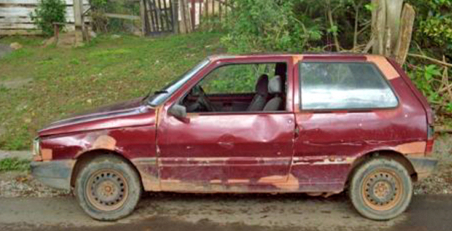 old red compact car in bad shape
