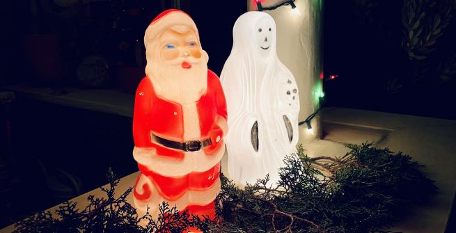 A santa and a ghost decoration on a porch