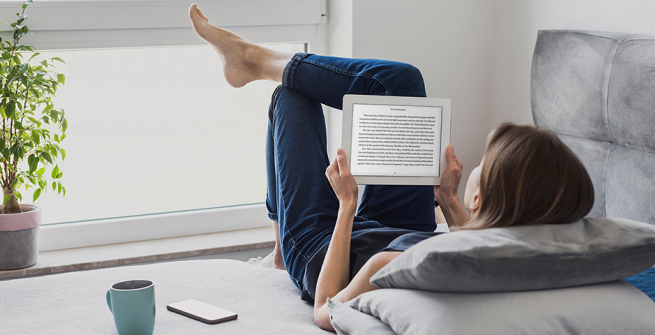 Girl reading a book on her tablet