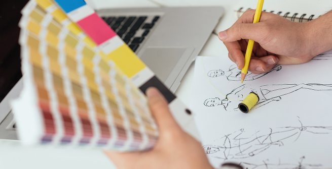 A close-up of a fashion drawing and color swatches