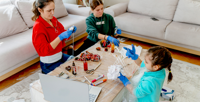 Family making crafts with online tutorial